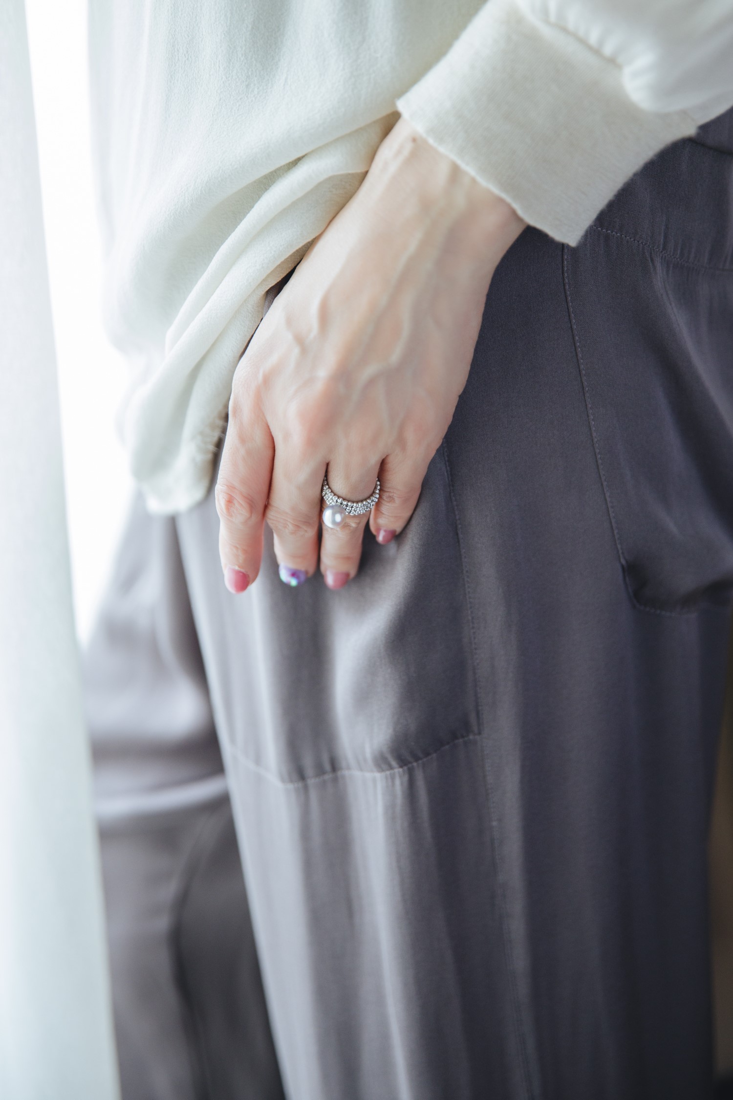 Pearl ring worn with soft neutral styling