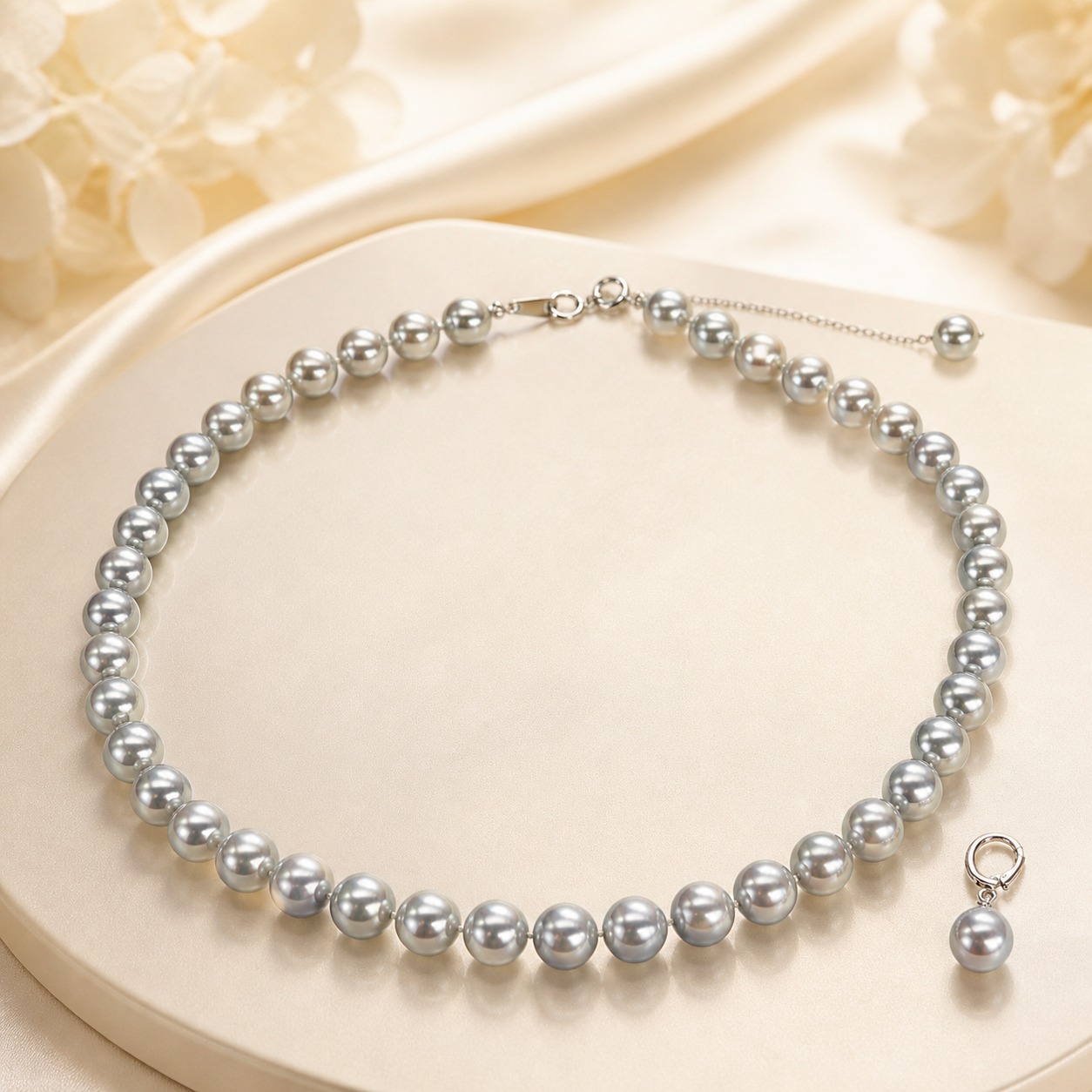 Gray Akoya pearl necklace set on ivory satin